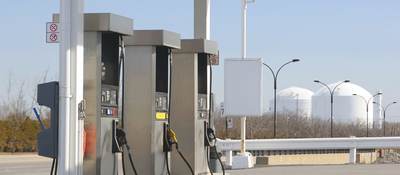 Three pumps at a gas station. 